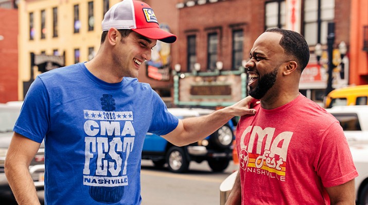 Men in CMAs shirts Talk Outside Buildings