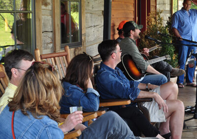 Group Tour on Porch at Leiper's Fork Distillery Listening to Country Music