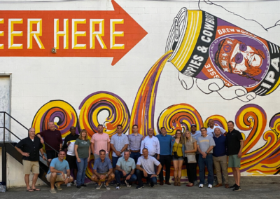 group in front of beer mural on beer tour of nashville