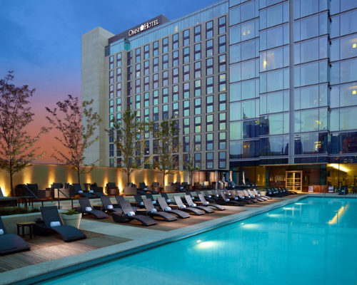 exterior view of the omni hotel with a pool 