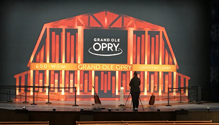 Grand Ole Opry stage with a person standing on it 