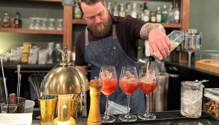 Bartender pouring drinks at a Louisville Cocktail Bar