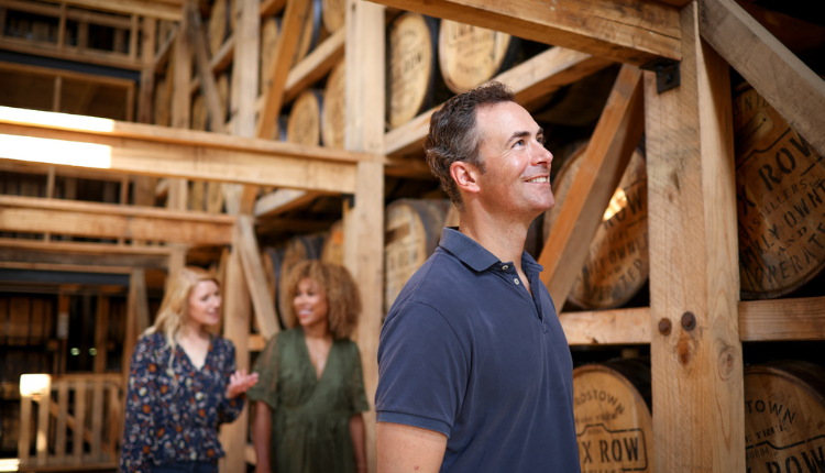 Man and two women on Distillery tour