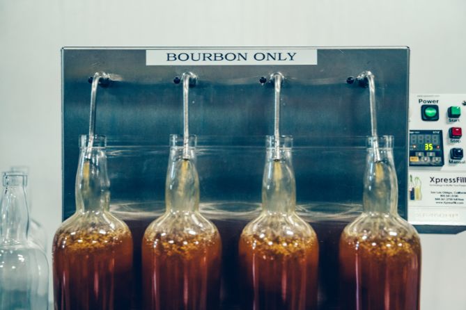 bottles being filled with bourbon at Bardstown Collection