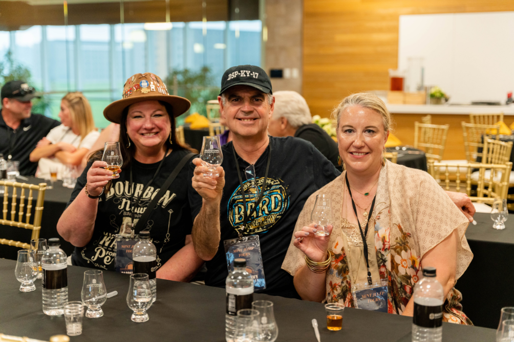 man and two women tasting bourbon from bardstown bourbon collection