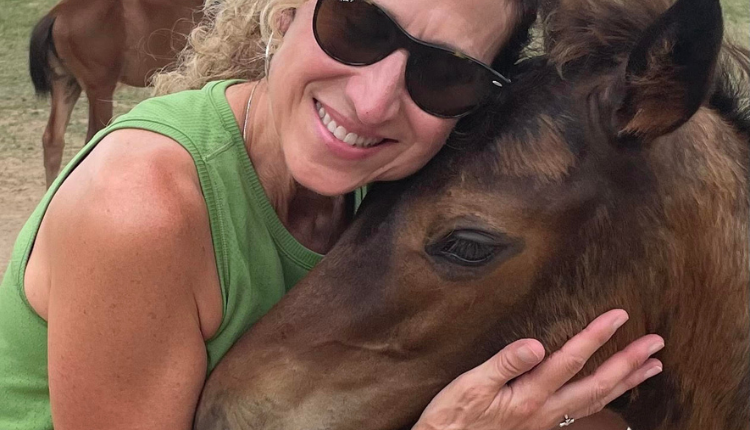 Woman hugging horse