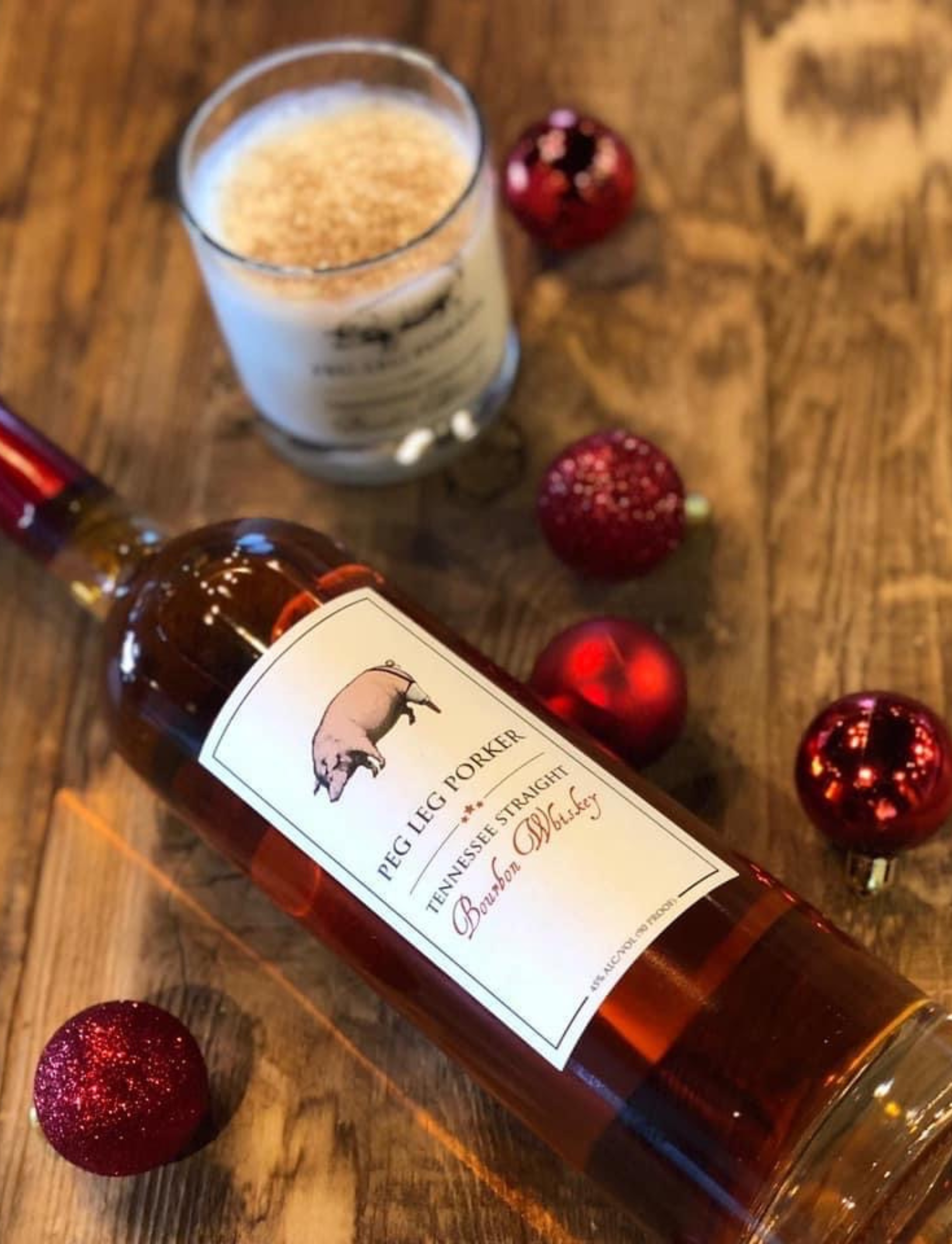 Bottle of Peg Leg Porker Bourbon Whiskey and festive cocktail