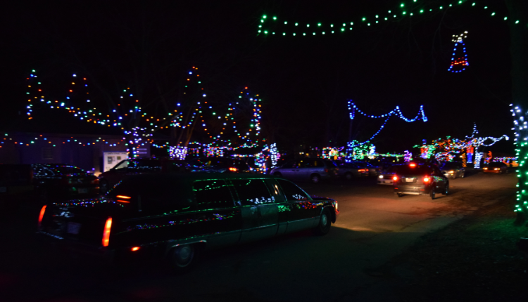 Vintage Limo Driving Through Christmas Lights And Decorations