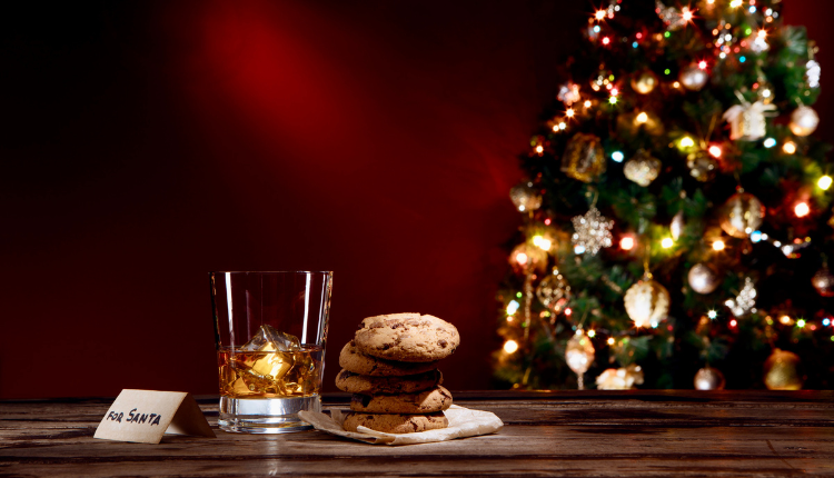 Whiskey and cookies for Santa by christmas tree